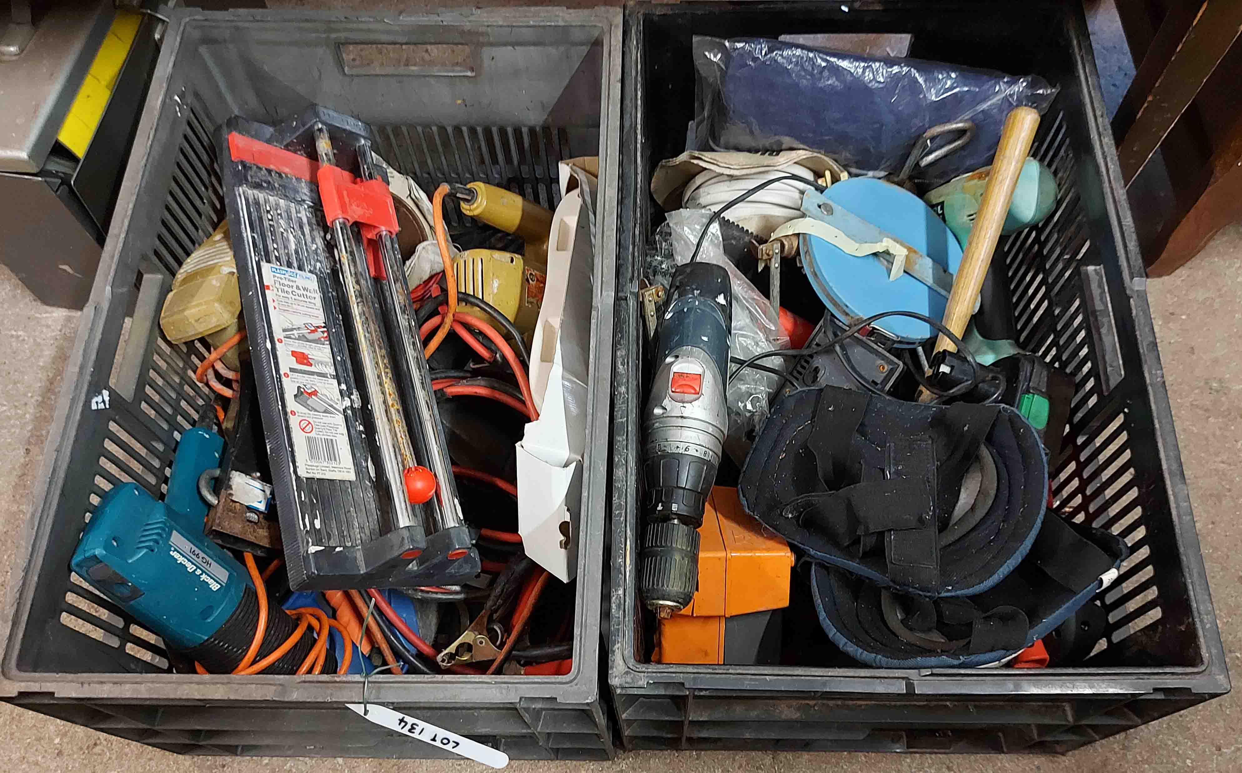 Two crates containing tools including drills, battery chargers, etc.