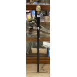 A modern walking stick with four sided head handle