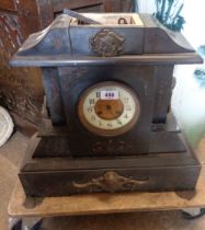 A large late Victorian black slate cased mantel clock of architectural design with eight day gong