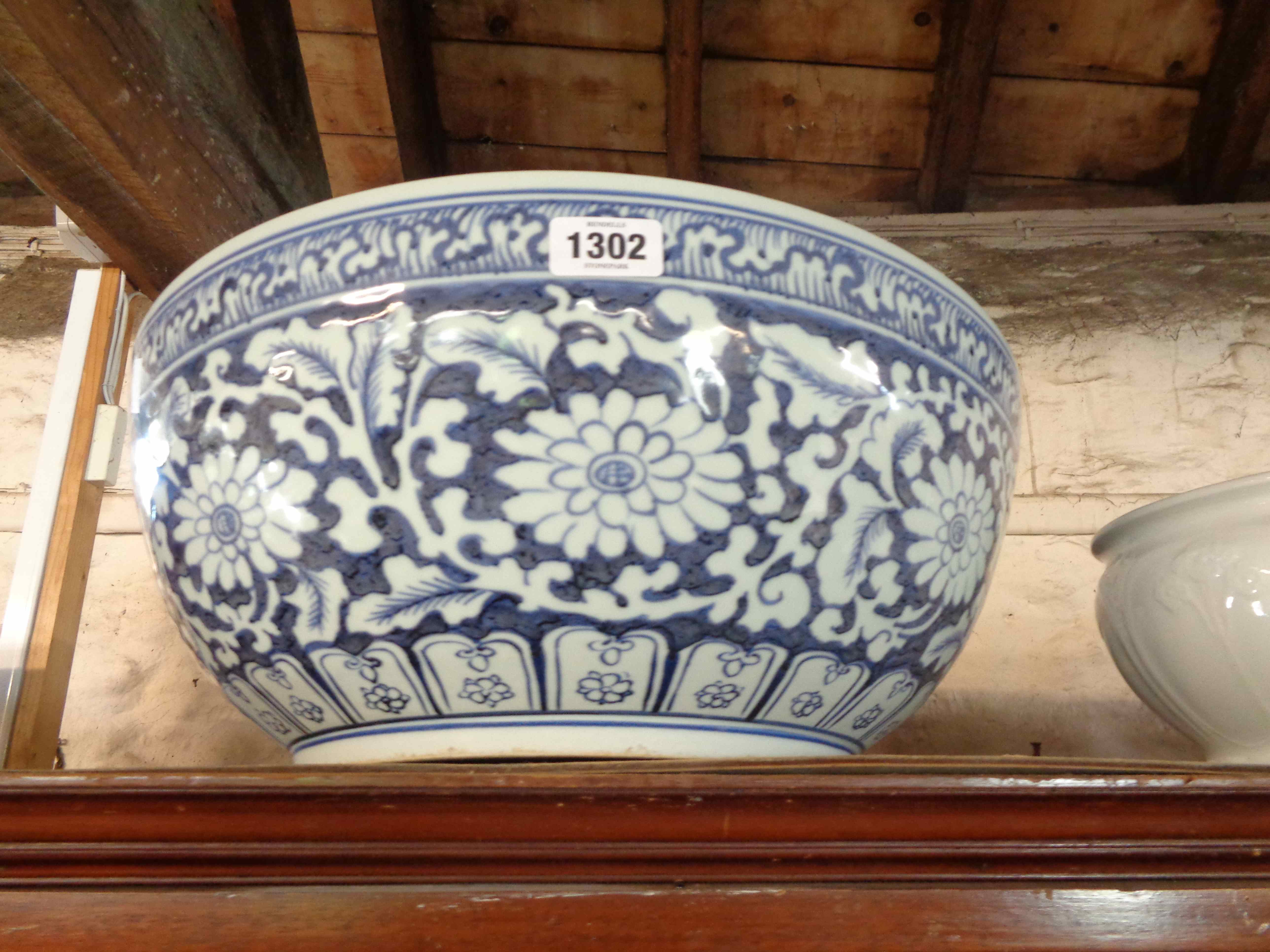 A large Chinese porcelain punch bowl with blue painted floral decoration