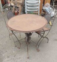 A decorative metal garden table and two chairs