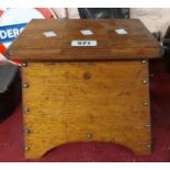 A vintage wooden box with shaped sides and lift-top lids