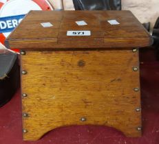 A vintage wooden box with shaped sides and lift-top lids