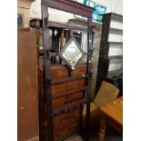 A reproduction mahogany hallstand with coat hooks and bevelled mirror panel