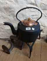 A large cast iron kettle on trivet - sold with a cast iron shoe last