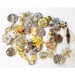 A tub containing a collection of costume jewellery brooches and stick pins