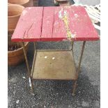 A metal framed table with red top - a/f