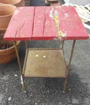 A metal framed table with red top - a/f