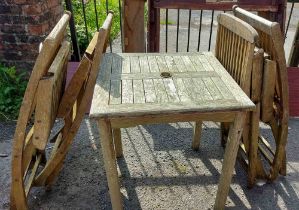 A teak garden table and chairs