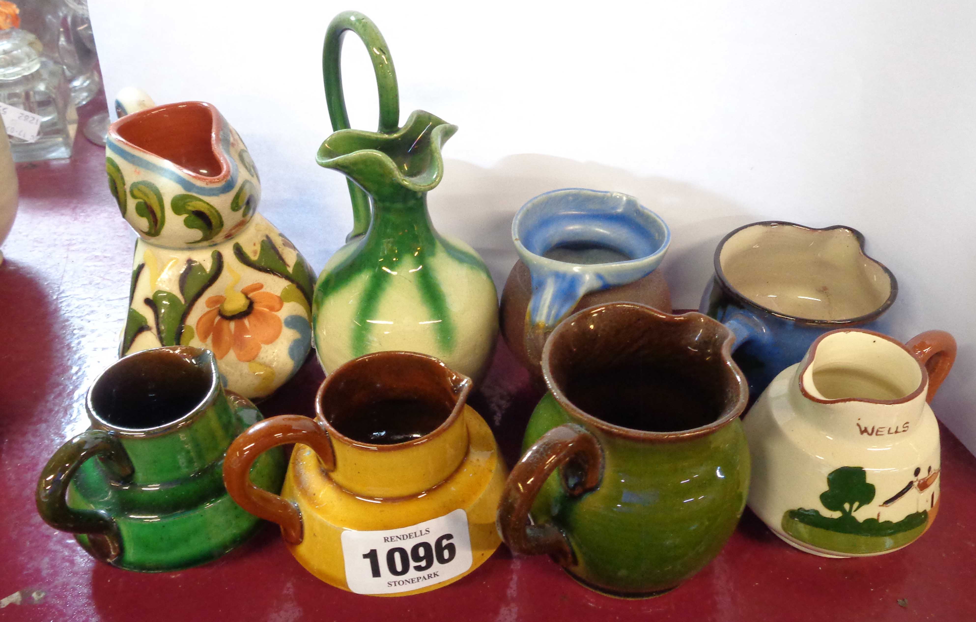 Eight small West Country pottery jugs including Torquay, Baron Barnstaple, etc.
