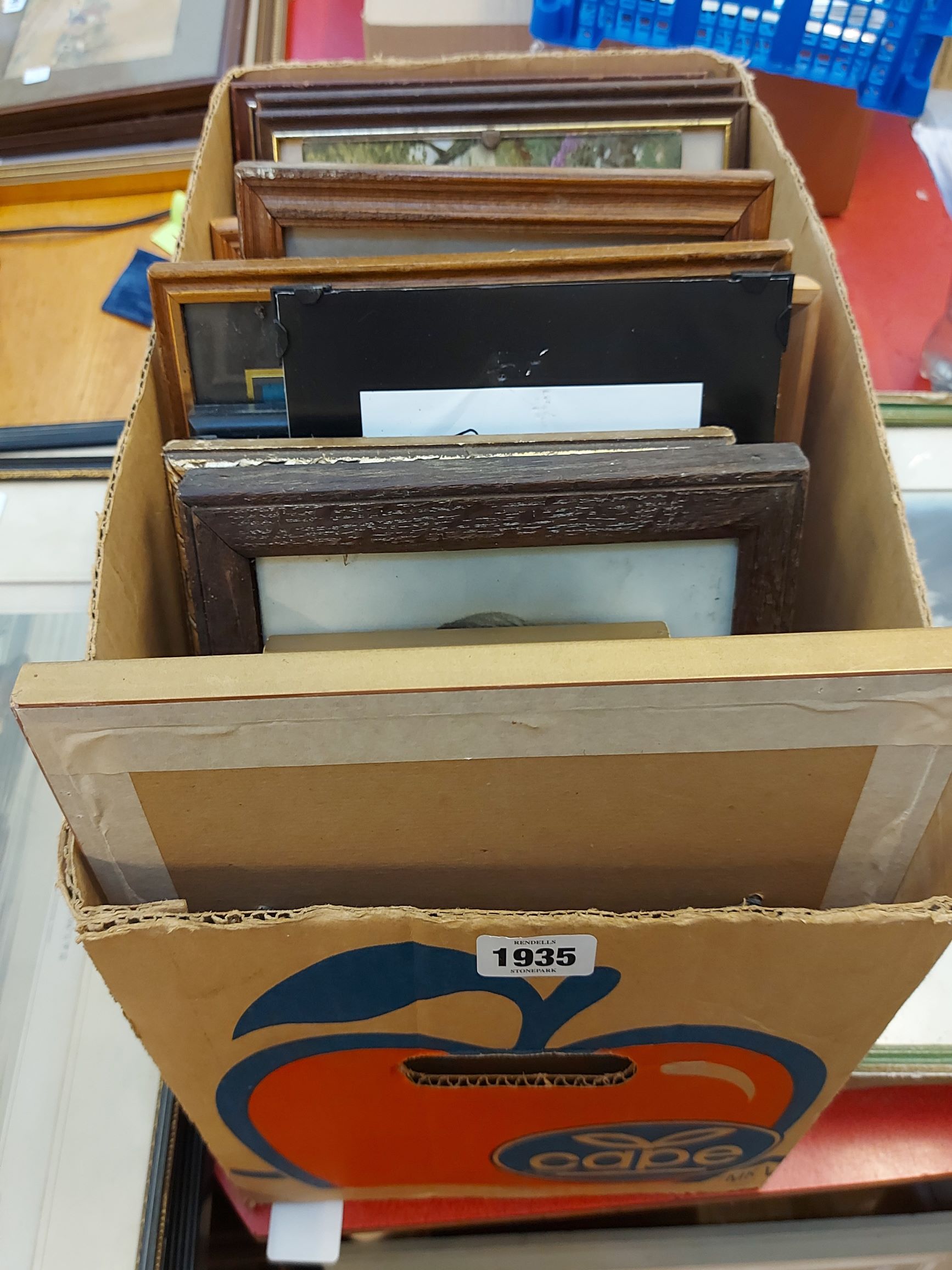 A box containing a quantity of framed coloured prints