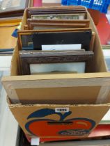A box containing a quantity of framed coloured prints