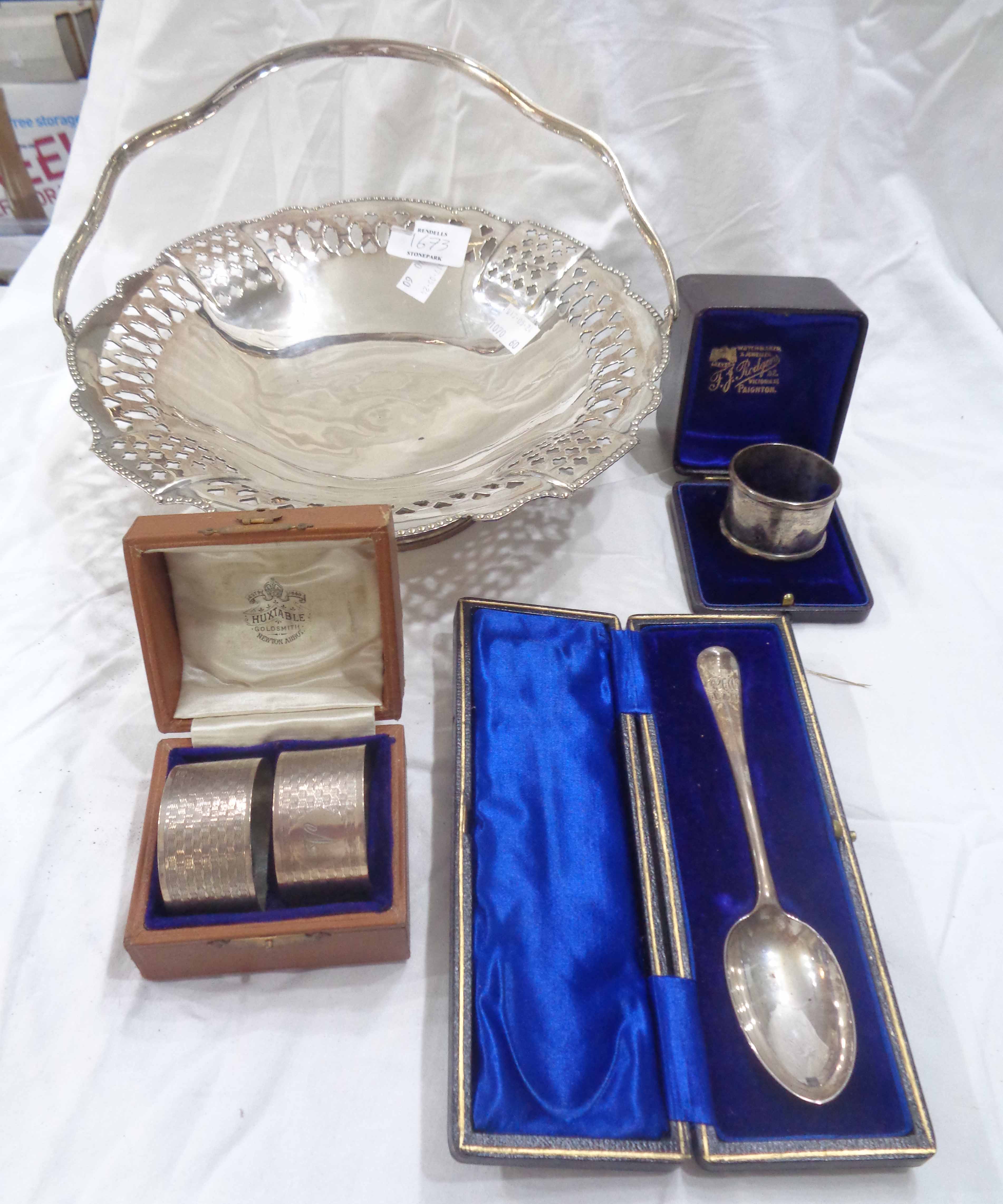 A cased silver spoon with initials to terminal, cased pair of silver napkin rings with 'V'