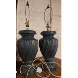 A pair of large black urn style ceramic lamp bases with coppered highlights