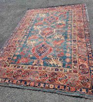 An old Persian handmade wool rug with repeat motifs on a blue and red ground - 1.5m X 1.85m