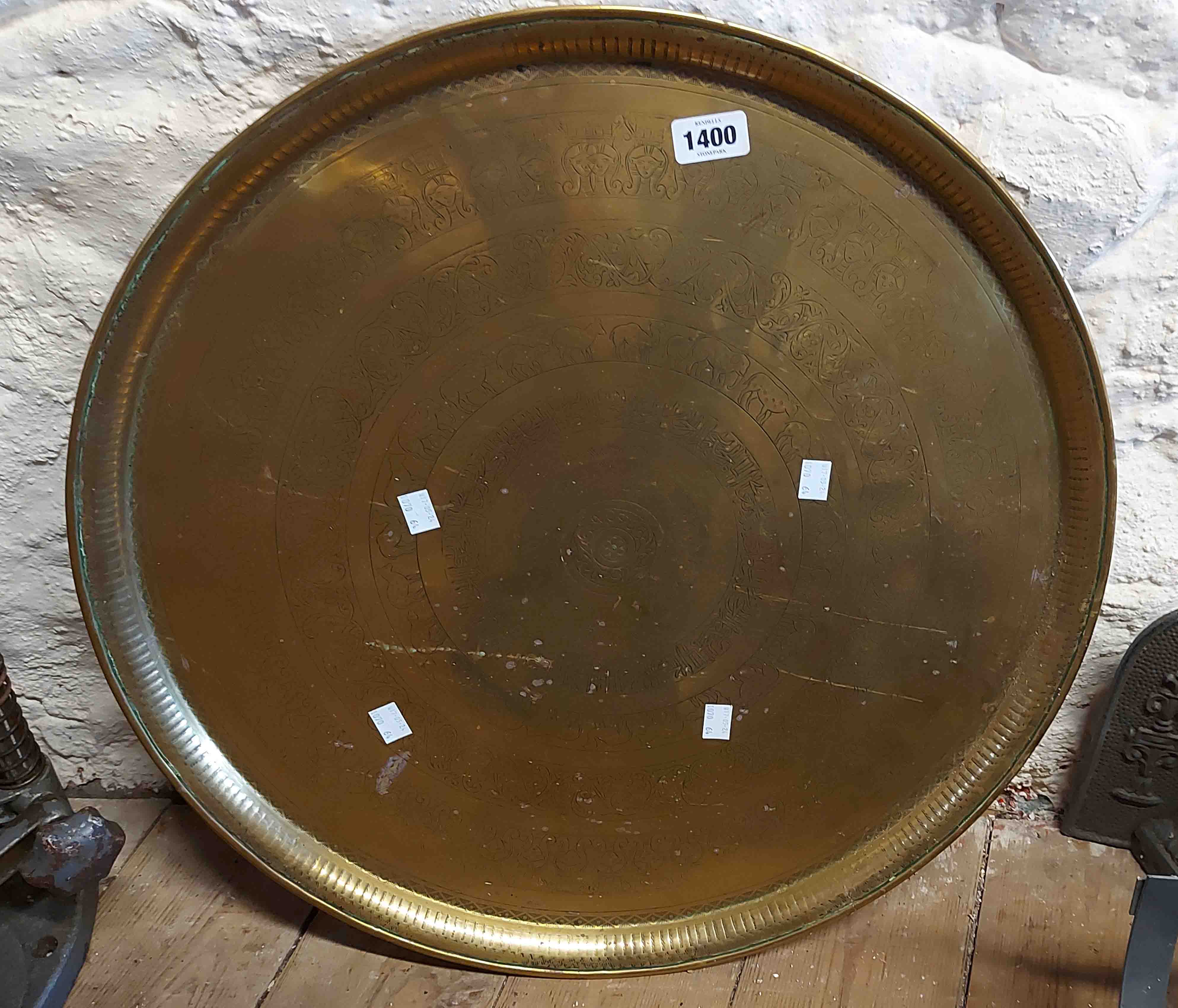 A large brass tabletop charger