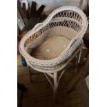 A vintage child's wicker cradle and stand
