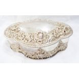 A 17cm Chester silver serpentine trinket box with hinged lid and bands of Rococo style embossed