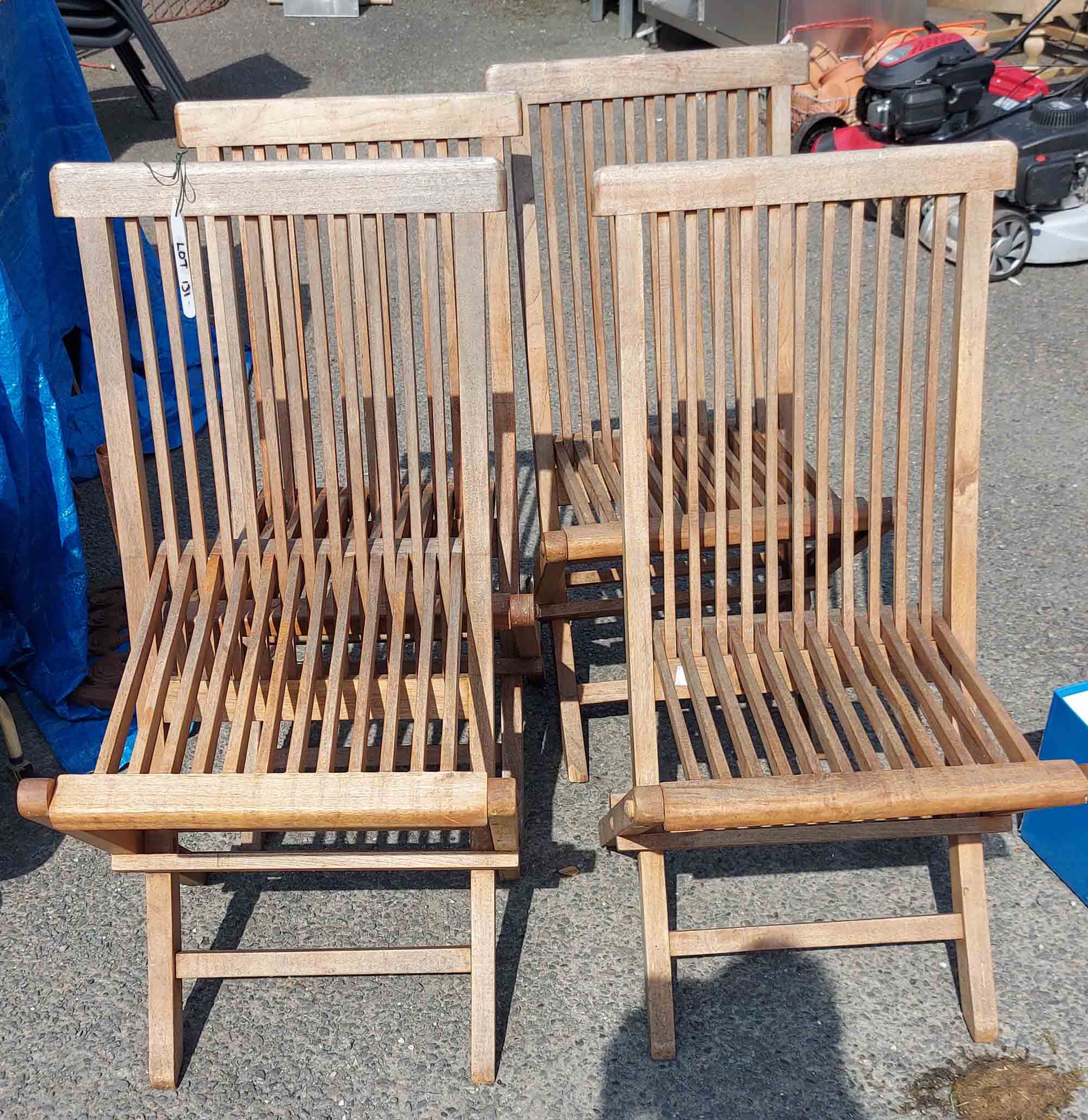 Four folding teak garden chairs