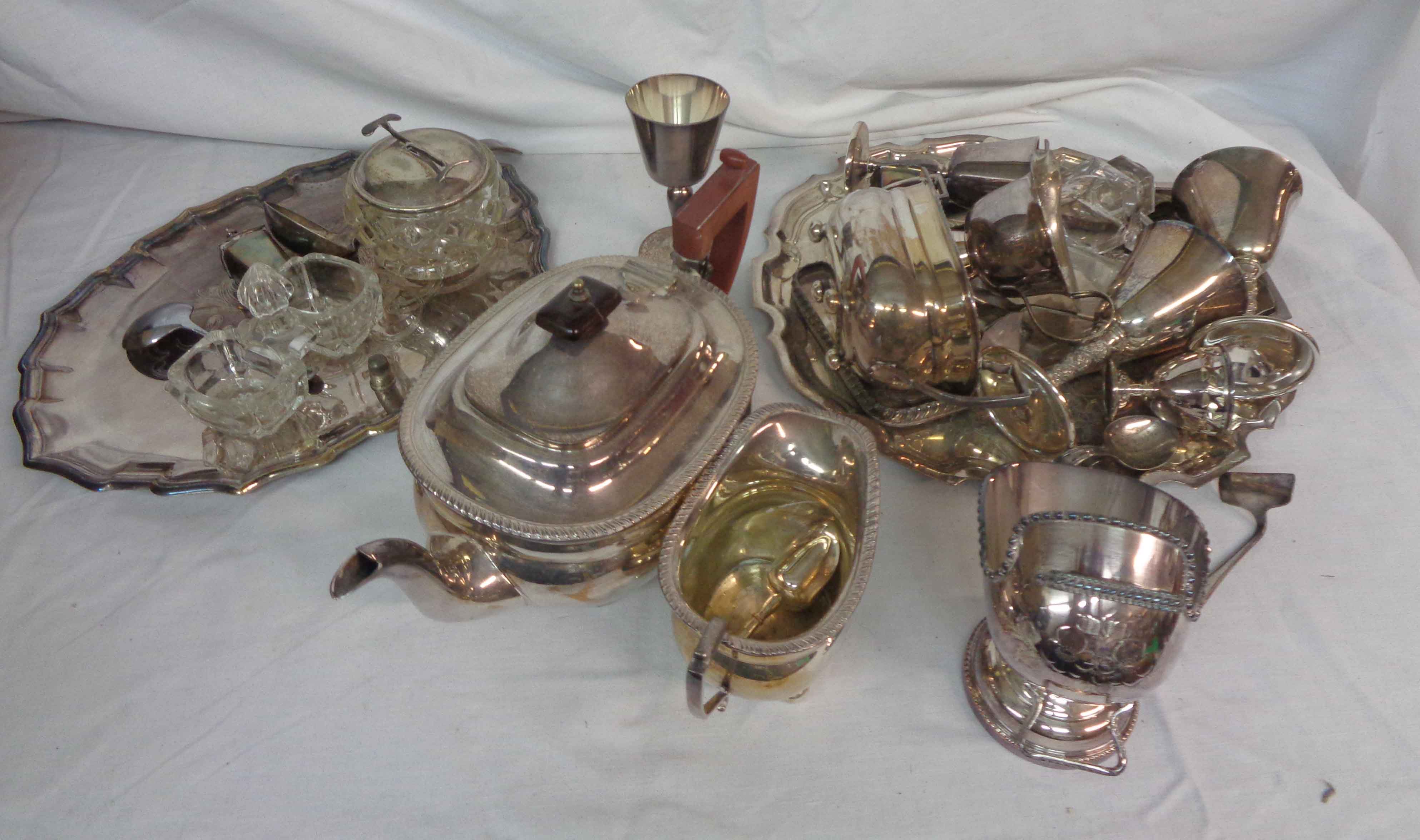 A box containing a quantity of assorted silver plated items including teapot, trays, etc.