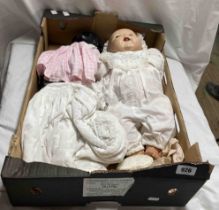 A box containing two vintage composition dolls - sold with extra items of clothing