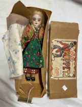 A Marco Puppets box containing a porcelain headed doll in the style of an Eastern European girl