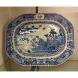 An antique Chinese porcelain meat plate, with blue hand painted Willow pattern decoration
