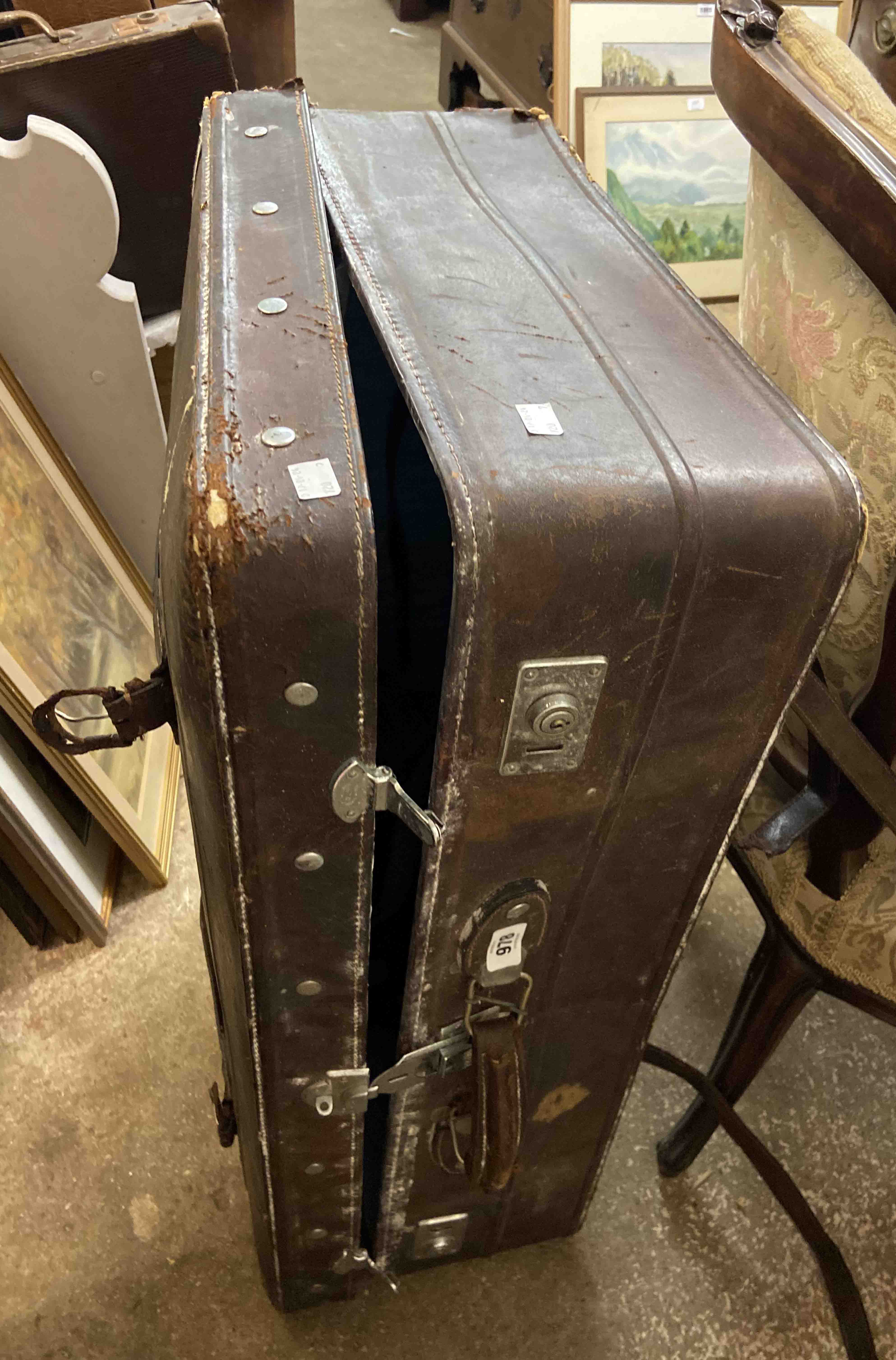 An old leather bound suitcase - sold with vintage leather suit cover