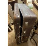 An old leather bound suitcase - sold with vintage leather suit cover