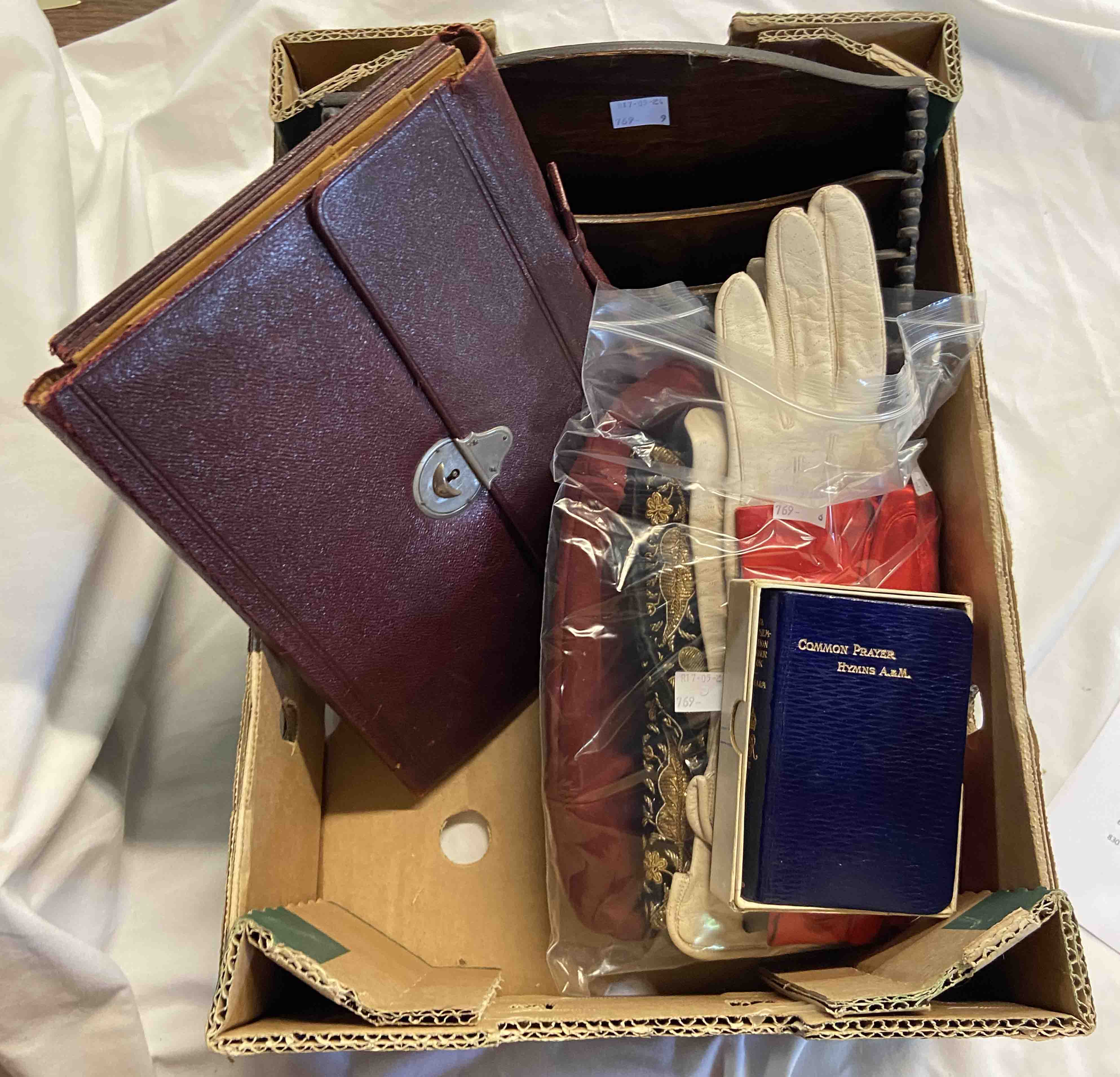 A box containing a quantity of mixed items including two vintage handbags, three pairs of lady's