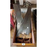 A wooden box containing a quantity of vintage saws including Spear & Jackson, etc.