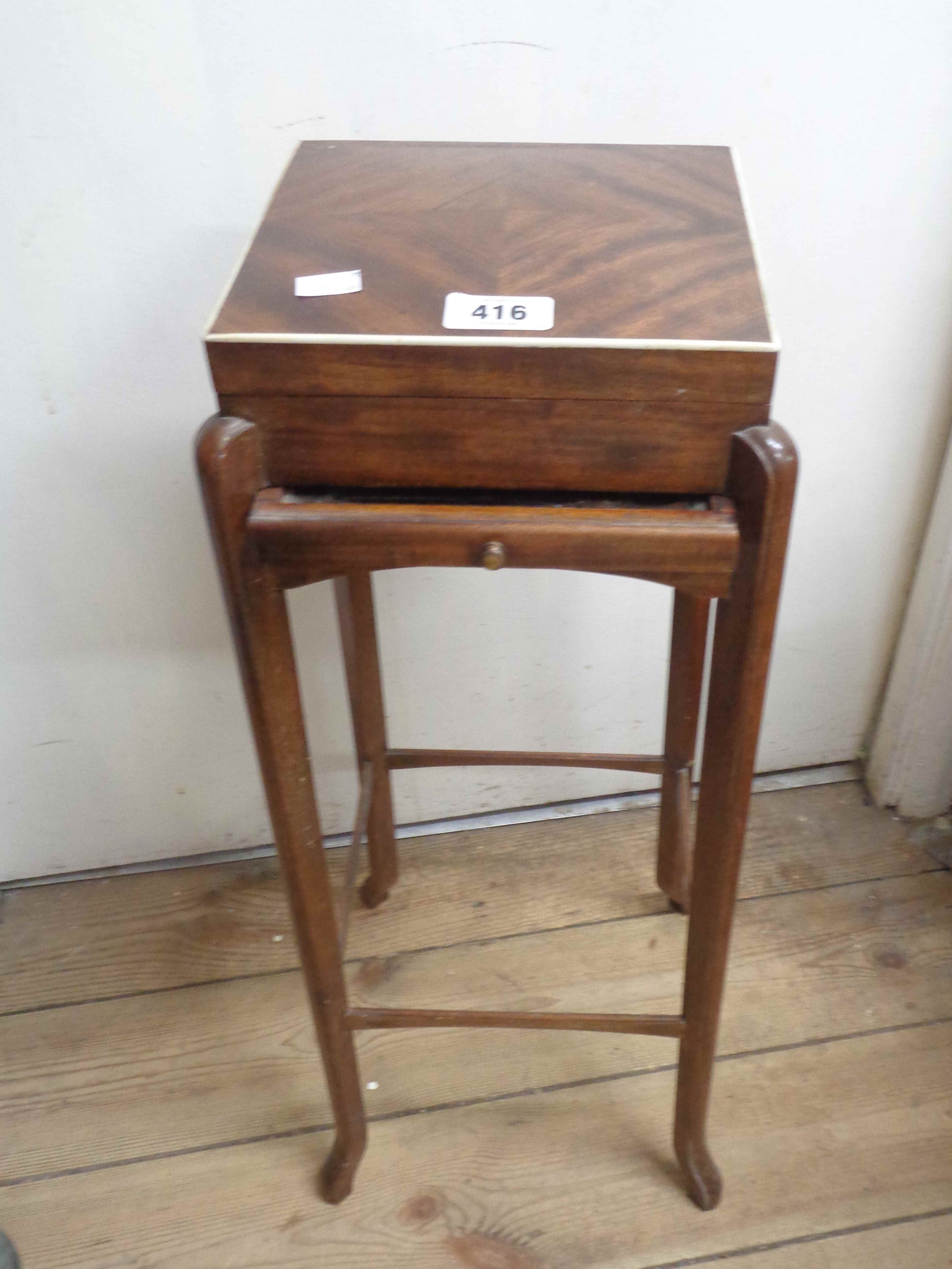 A vintage mahogany and strung gentleman's grooming table with mirror to underside of lift-top and