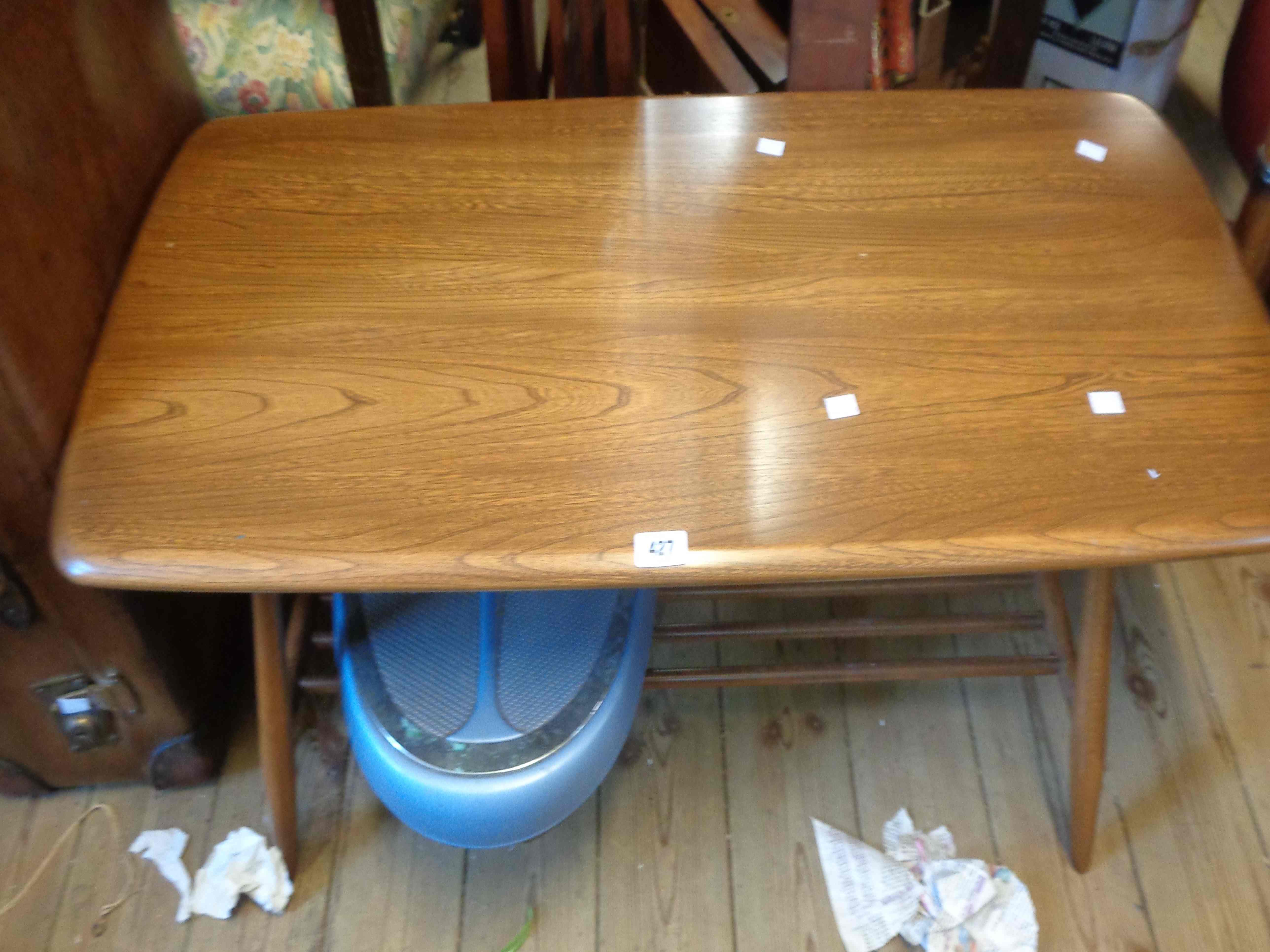 A 100cm vintage Ercol elm coffee table, set on turned supports with undertier