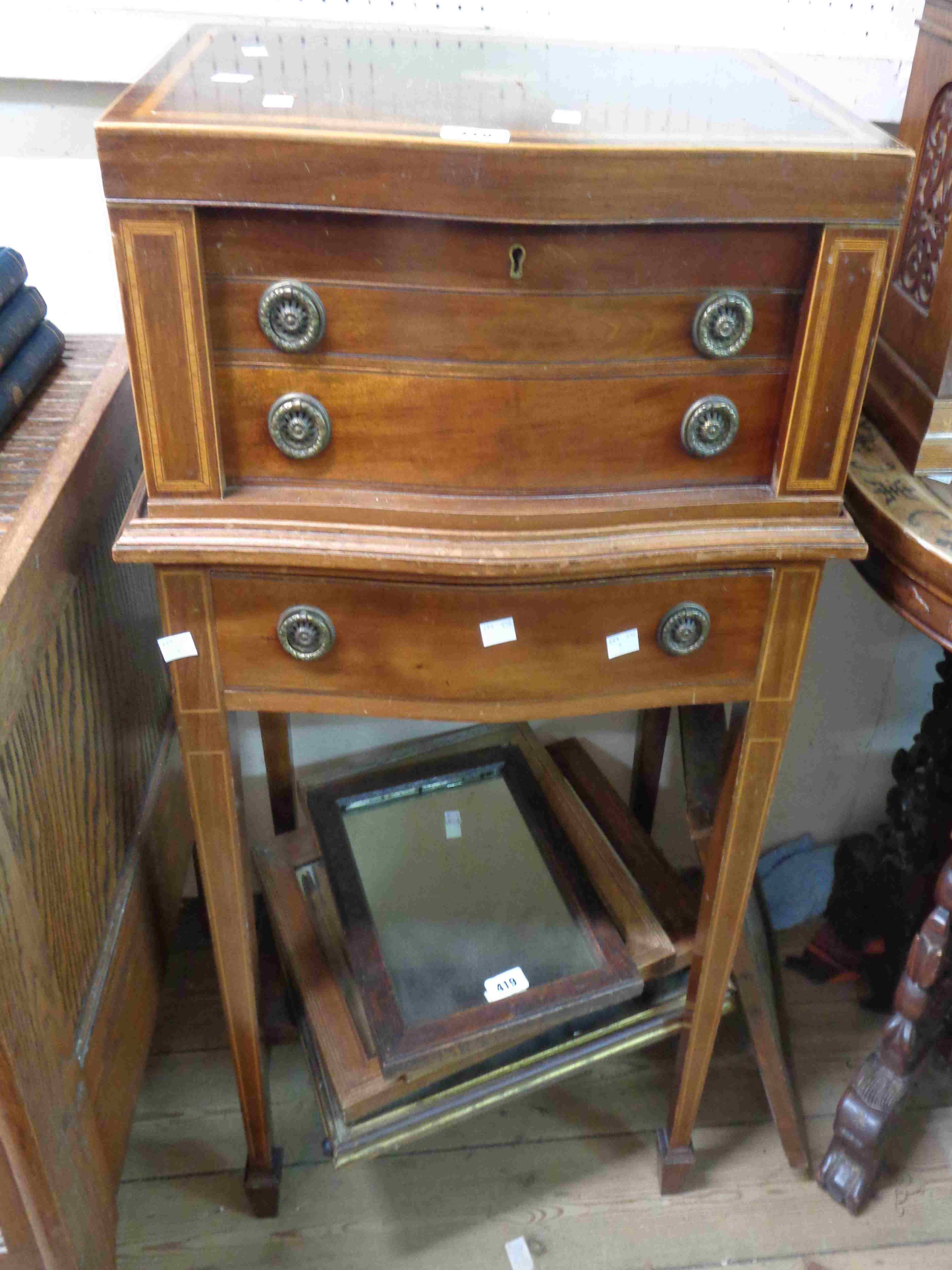 A 48cm Edwardian mahogany and strung serpentine front cutlery canteen on stand with lift-top and