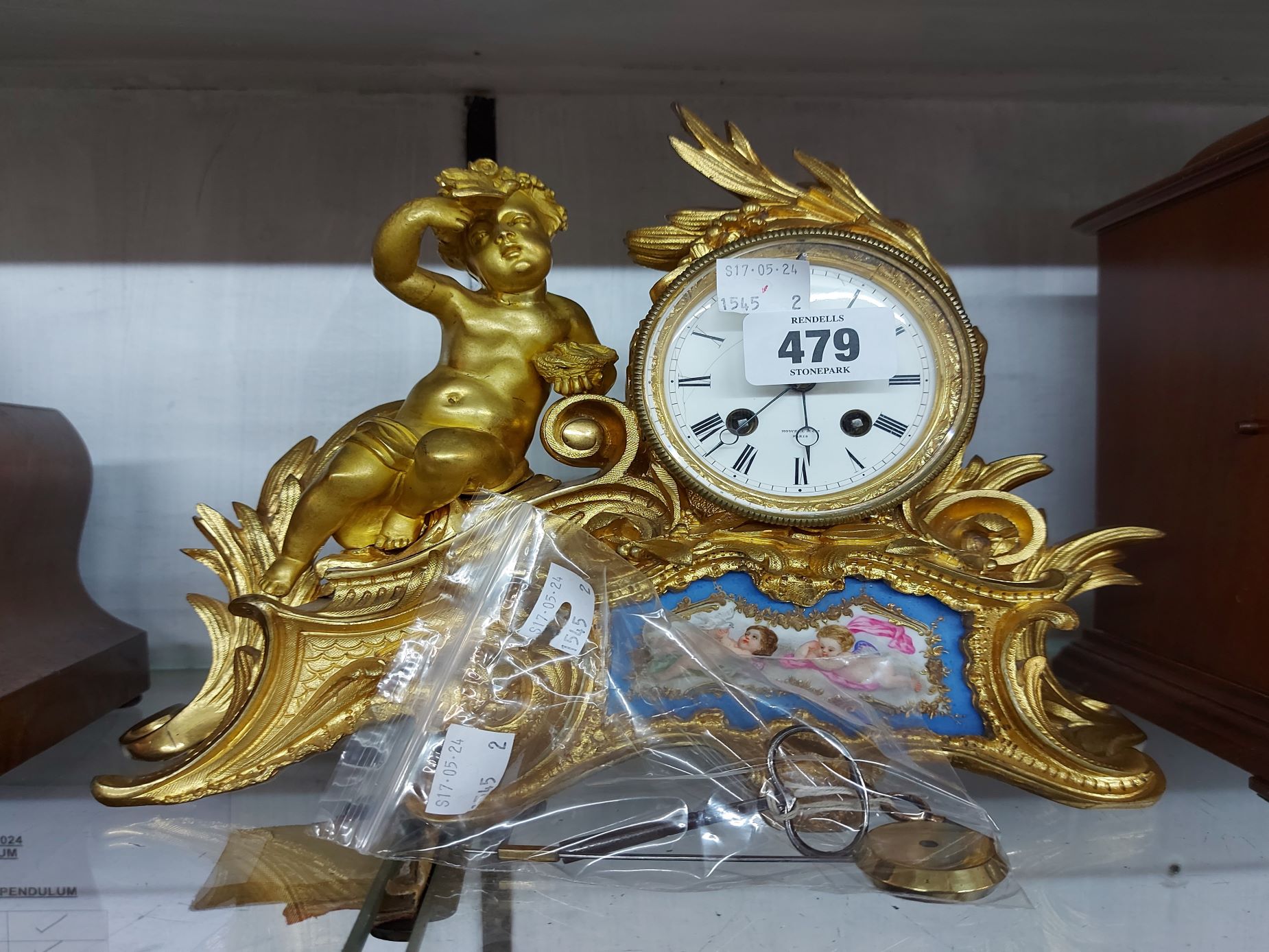 A 19th Century French ormolu salon clock with figure of a putto holding a bird seated beside the - Image 2 of 2