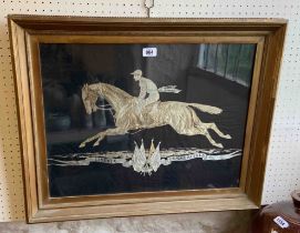 A framed and glazed brocaded black silk taffeta panel with woven horse and rider - by Tassinari