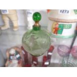 A 19th Century green glass scent bottle and stopper with typical Mary Gregory, decoration