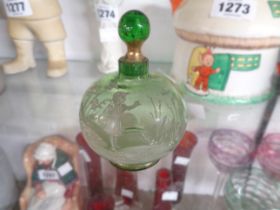 A 19th Century green glass scent bottle and stopper with typical Mary Gregory, decoration