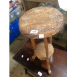 A small Eastern carved wood table with floral petal decoration, set on cabriole supports with