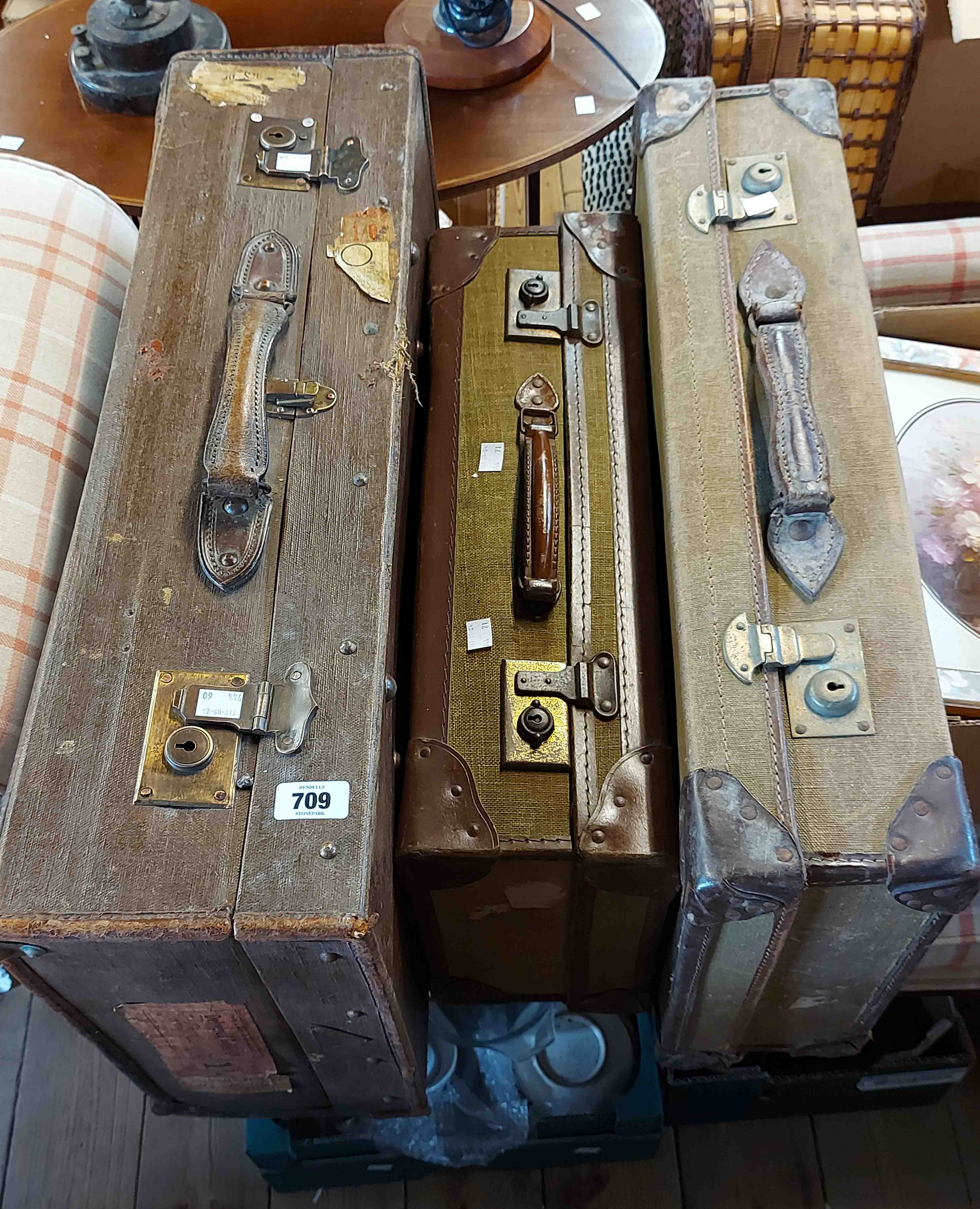 Three old canvas and leather bound suitcases