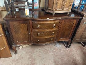 A 1.5m 1930's mahogany break bow front sideboard with three central drawers and flanking