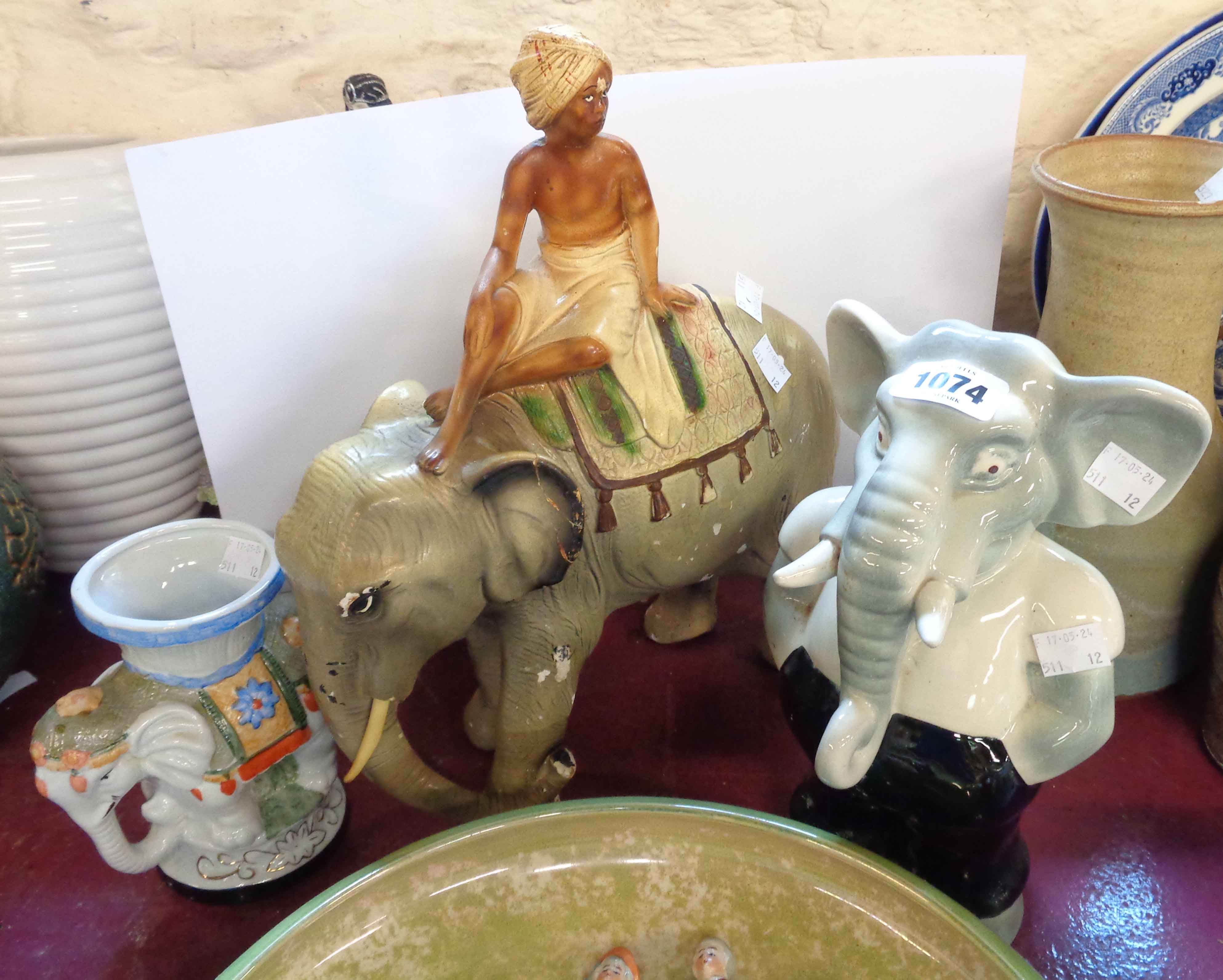 A vintage plaster figurine, depicting an elephant and rider - sold with a ceramic elephant form