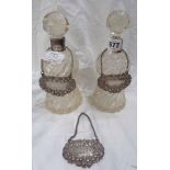 A pair of cut glass small spirit decanters of waisted form with silver collars and faceted