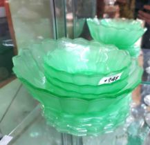 A quantity of 1930's pressed green uranium glass bowls and plates