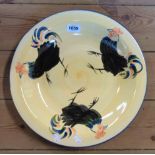 A large pottery dish with hand painted cockerel decoration