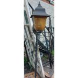 A wrought iron outdoor standard lamp