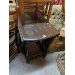 A 98cm vintage polished oak gateleg dining table, set on turned supports