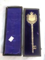 A cased 21cm silver plated presentation key for the opening of the 'Petit Hospital Ward at the