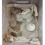 A crate containing a Brains Foley bone china part coffee set, with floral decoration on a green