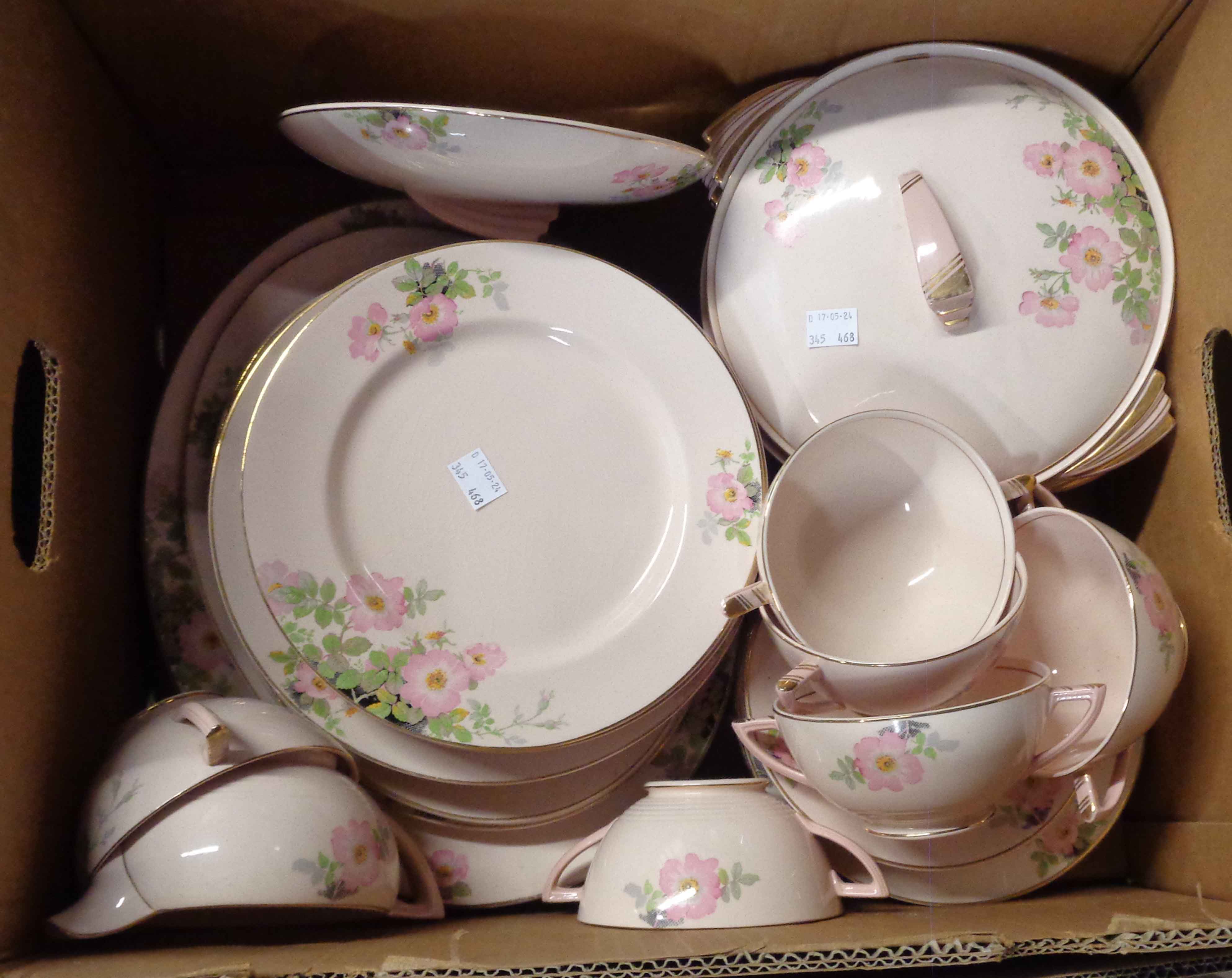 A box containing a quantity of Enoch Wedgwood Art Deco tableware on a blush rose ground and